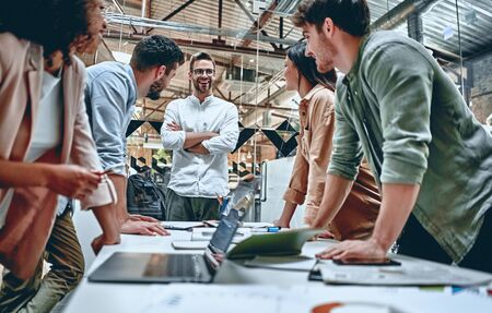 Group of young multiracial business people are working in modern office. Freelancers in coworking place. Creative and stylish youth.の写真素材