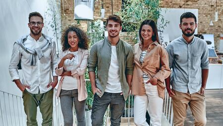 Group of young multiracial business people are working in modern office. Freelancers in coworking place. Creative and stylish youth.の写真素材