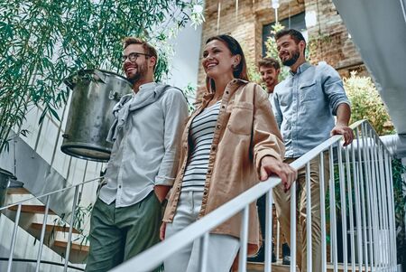 Group of young multiracial business people are working in modern office. Freelancers in coworking place. Creative and stylish youth.の写真素材