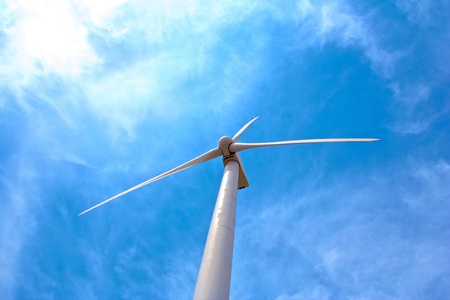 Windmill pictures from the bottom with clouds in the skyの写真素材