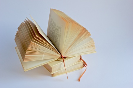 Open book is on a pile of two othersの写真素材