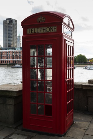 Traditional red telephone box by the river thamesの写真素材