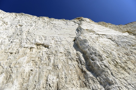 A chalky white cliff face against a blue skyの写真素材