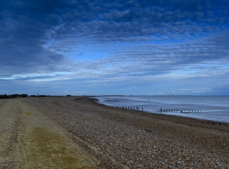 View along a sandy and pebble beachの写真素材