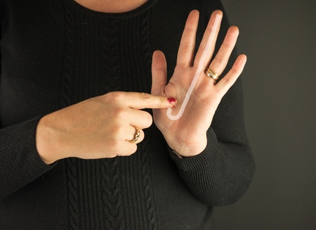 Woman Demonstrating Sign Language letter Jの写真素材