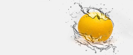 Orange splash of juice or water.  isolated on white backgroundの写真素材