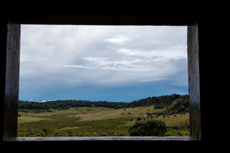 Looking through a window at a landscapeの写真素材