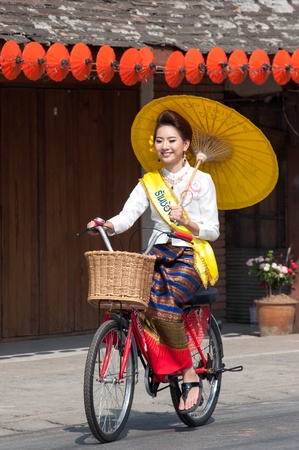 CHIANG MAI, THAILAND-JANUARY 18 : 30th anniversary Bosang umbrella festival,Woman in traditional costume during the annual Umbrella festival at San Kamphaeng. on Jan.18, 2013 in Chiang Mai, Thailand.のeditorial素材