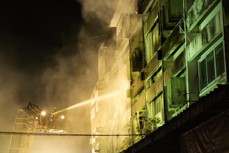 CHIANGMAI THAILAND  JUNE 5 : Warorot market fire. Firefighters were spraying water to extract the fire from spreading to adjacent buildings. on June 5  2015 in Chiang MaiThailand.のeditorial素材