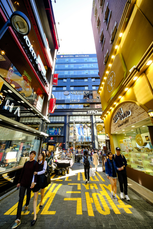 SEOUL, KOREA - OCTOBER 3, 2015 : Myeong-Dong shopping street, Korean people tourists walking shopping the neighbourhood. It is fashionable to be the most popular. neighbourhood is must when traveling.のeditorial素材