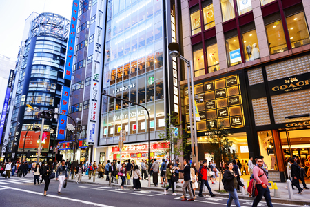 TOKYO JAPAN - APRIL 1, 2018 : Shinjuku neighborhood, Unidentified young tourists walk past this area has many shops full to shopping and restaurants. One of Tokyo's must-see places to visit.のeditorial素材
