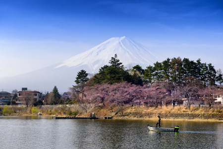 YAMANASHI JAPAN - APRIL 3, 2018 : Kawaguchi lake, Japanese men are fishing in the middle of the lake. Behind the scene is Mt. Fuji, famous tourist to visit & stay here. Japan must-see places to visit.のeditorial素材