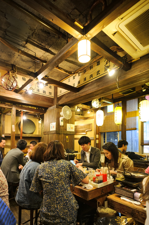 TOKYO JAPAN - MARCH 29, 2018 : Shinjuku neighborhood, After work Japanese people gather to eat and drink fun. interior of the restaurant is simply decorated in a unique contemporary Japanese style.のeditorial素材