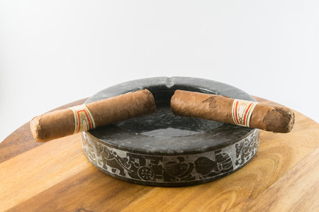 Cuban cigars on stone ashtrayの写真素材