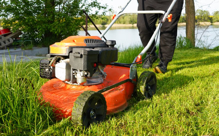 Lawn mower cutting grass on a sunny summer day, cutting grass