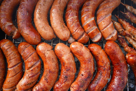 grilled sausages on a barbecue grill, close-upの写真素材