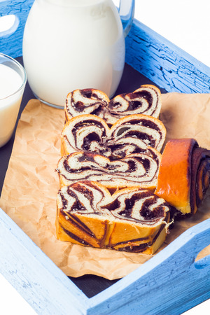 The roll cut and milk on an old trayの写真素材