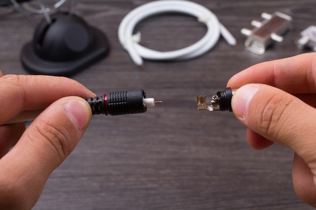 The person fixes antenna connections on a tableの写真素材