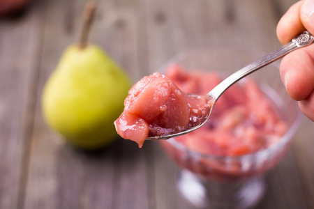 Jam pear in a bowl, on a table, with a small depth of sharpnessの写真素材