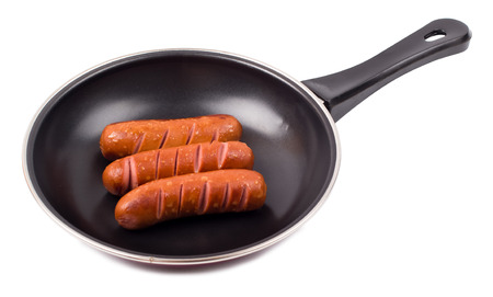 Fried sausages in a frying pan isolate,  top viewの写真素材