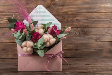 Floral bouquet. Arrangement in an envelope of flowers in soft pink with cottonの写真素材