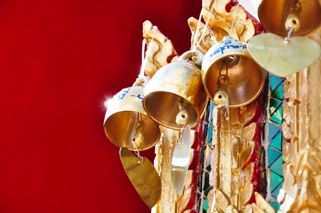 bells on red background at temple の写真素材