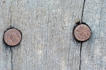 rusty nails on old wooden texture backgroundの写真素材
