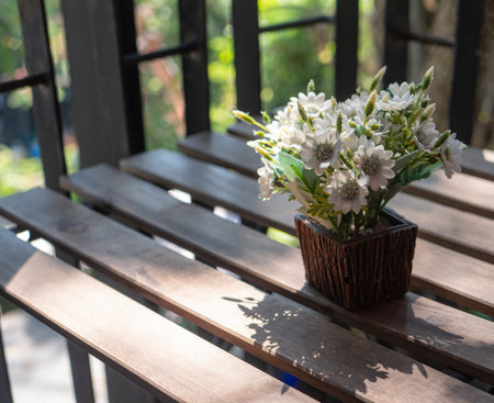 Bouquet of white flowers in a vase on a wooden tableの写真素材