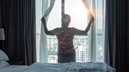 A woman is happy in her bed in the morning.の写真素材