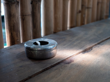 a cigarette ashtray on an old wooden table.の写真素材