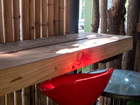 Old wooden table and red chairs.