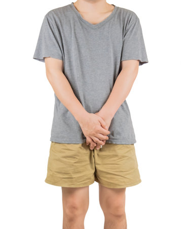Young man holding his hands on his chest, isolated on white backgroundの写真素材