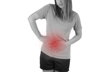 Woman suffering from backache on white background. Health care concept.の写真素材