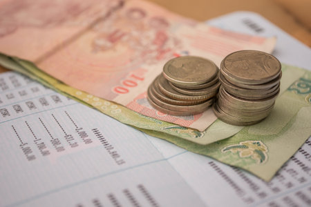 Thai baht banknotes and coins on the table.の写真素材