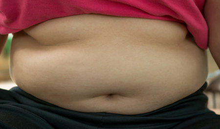 Fat woman with overweight. Close up of fat woman's stomach.