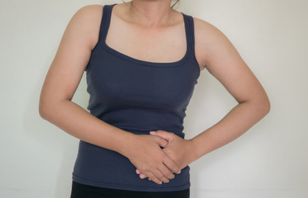Woman suffering from stomachache on white background. Health care concept.の写真素材