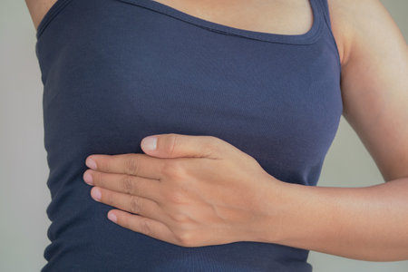 Woman suffering from stomach pain on gray background. Health care and medical concept.