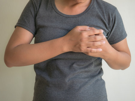 Man holding hand on chest pain. Health care and medical concept.の写真素材