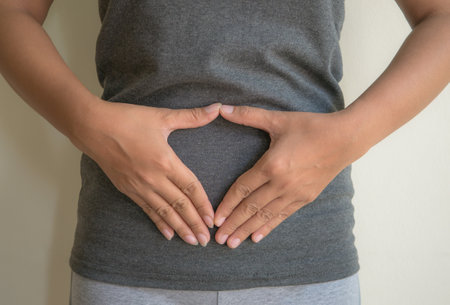 Pregnant woman holding hands on her belly with copy space.の写真素材