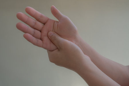 Close up of man and woman hands holding each other on white backgroundの写真素材
