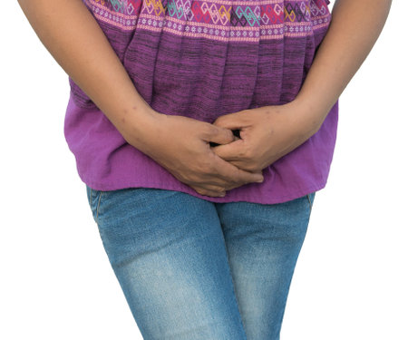 Woman suffering from stomach ache isolated on white background with clipping pathの写真素材