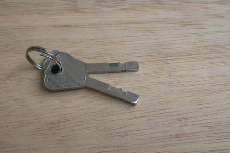 Bunch of keys on a wooden background, close-up.