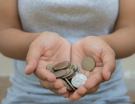 Coins in woman hand, save money for prepare in the futureの写真素材