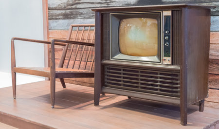 Vintage television and chair on wood floor in living room, stock photoの写真素材
