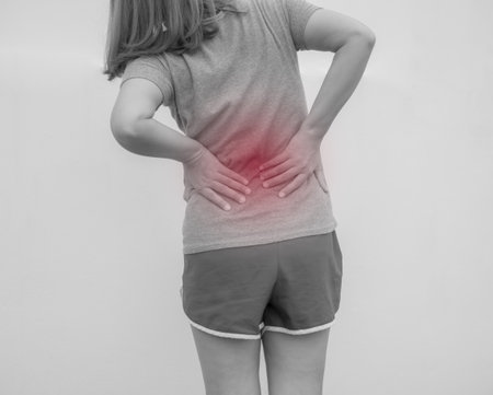 Young woman suffering from backache. Health care and medical concept.の写真素材