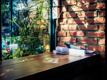 corner in the garden has chairs and wooden tables.
