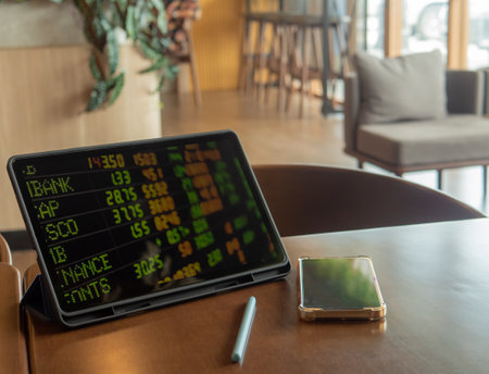 Tablet placed on a wooden table in a coffee shopの写真素材