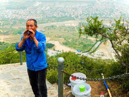 An elderly selling goat's milk on top of mountainのeditorial素材