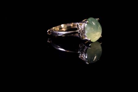 green gemstone ring on black backgroundの写真素材