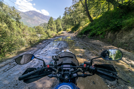 Riding a motorcycle on an empty Road in Sankri Range, Uttrakhand, Indiaの写真素材